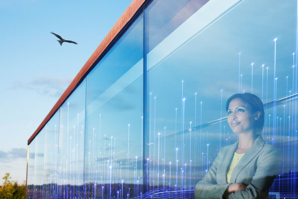 A woman looking out a window with a bird right outside with modern graphics