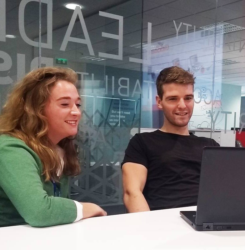 colleagues sitting in front of laptop