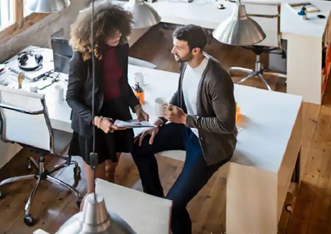 Man and woman conversing in an office