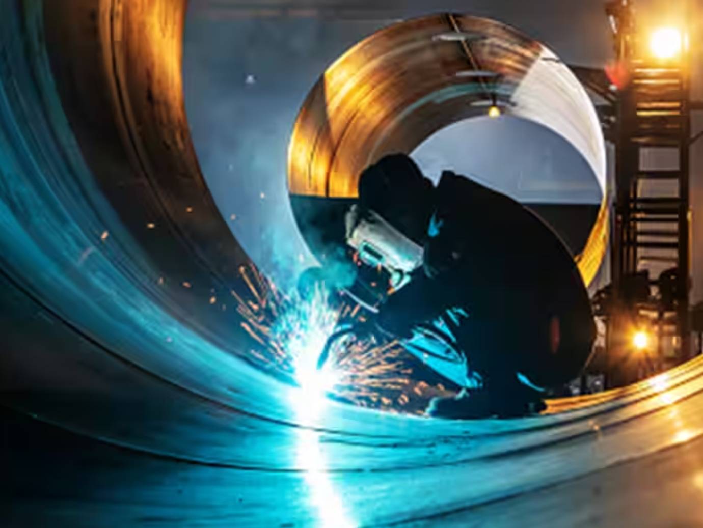 A mechanic welding at an industrial site