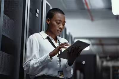 A businesswoman scrolling on a tablet