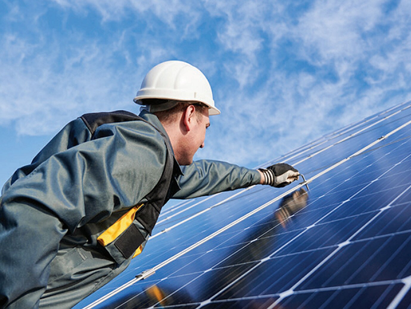technician installing solar panel