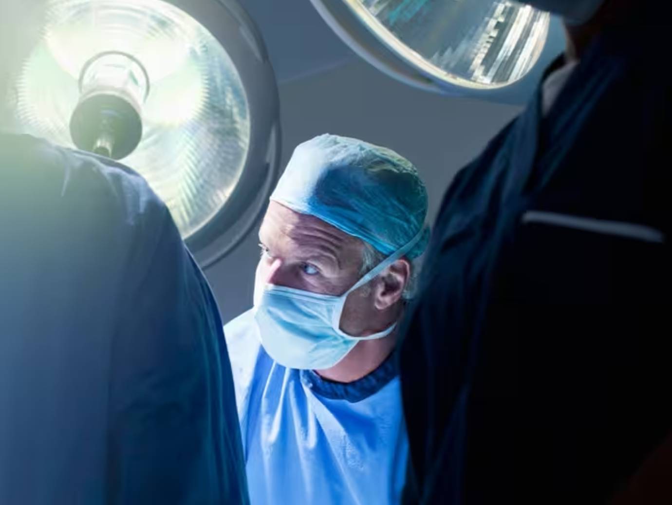 Surgeons performing an operation in an operating room.