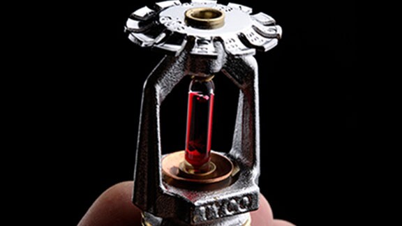 person holding fire sprinkler