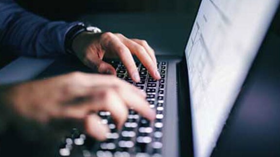 person working on laptop closeup