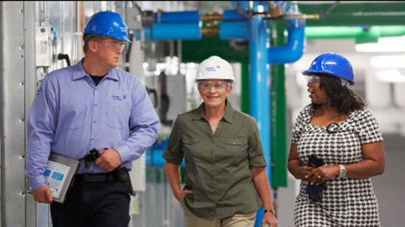 three people in safety helmets