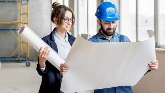 Employees in a construction facility consulting charts