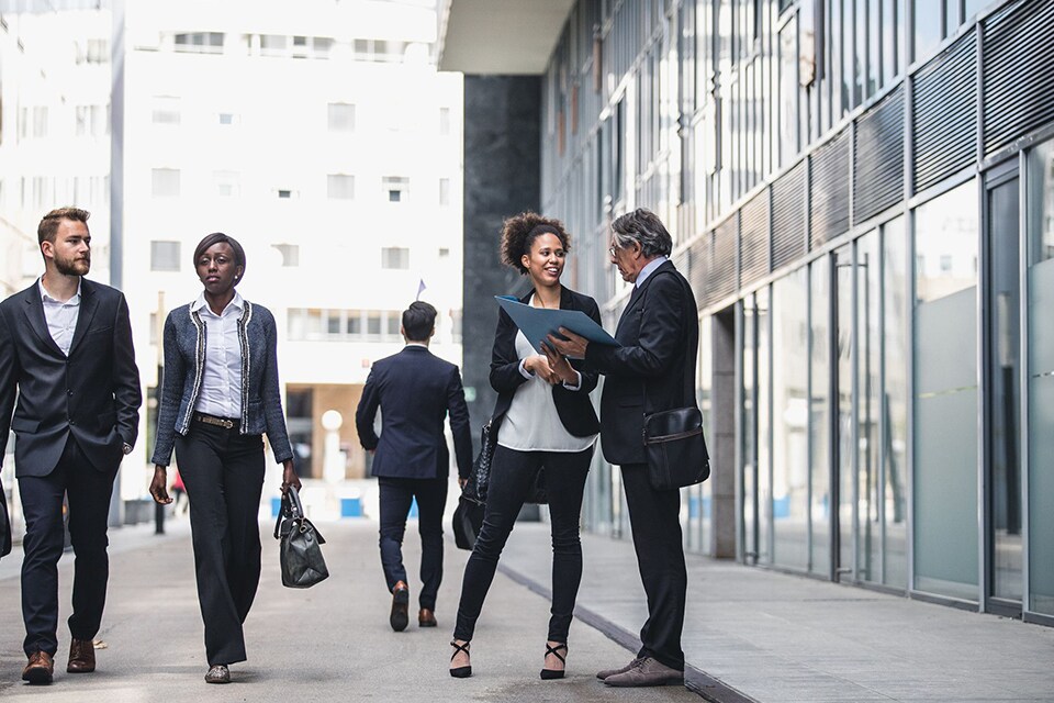 colleagues walking in office outdoor corridor