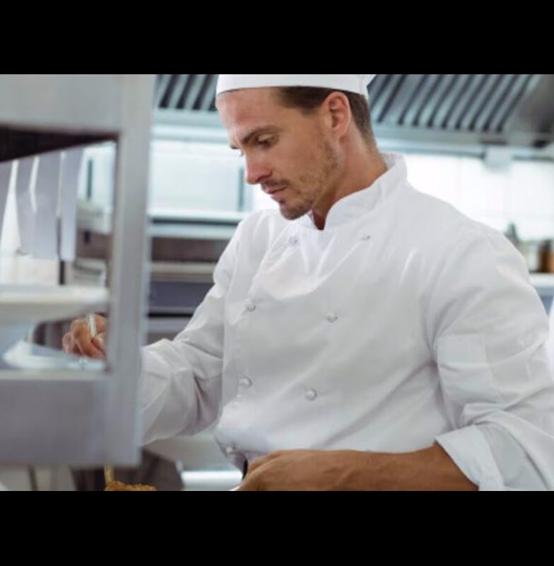 Chefs preparing meals in a restaurant kitchen