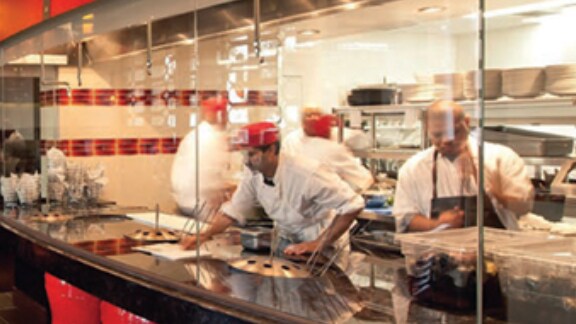 chefs working in the live kitchen of a restaurant