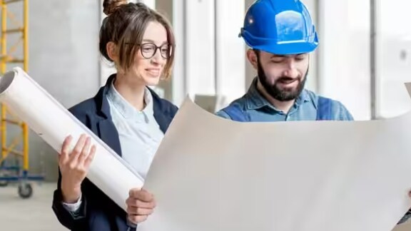 Two engineers looking a chart