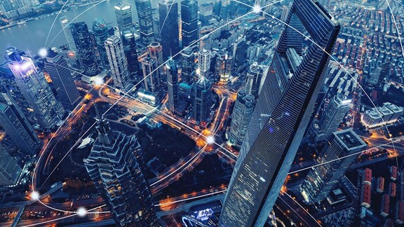 Bird's eye view of a cityscape with a graphic depicting digital networking