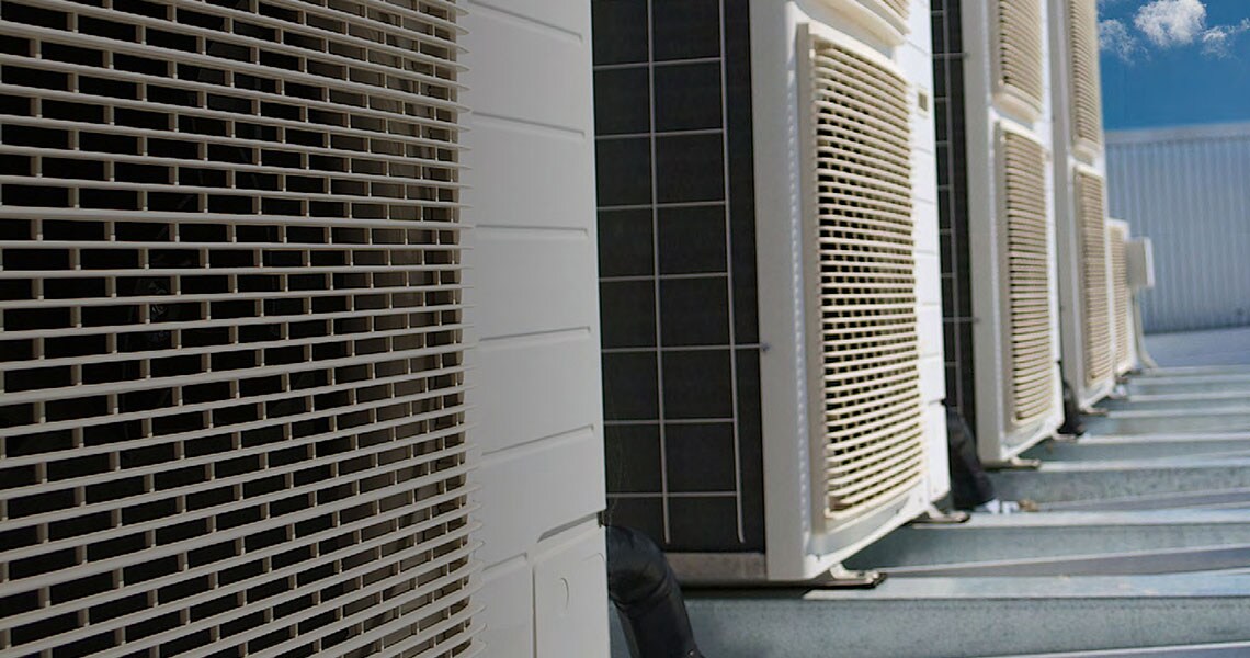 HVAC equipment in a line on the roof of a building