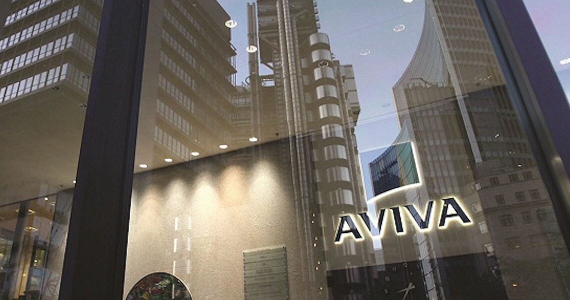 Reflections of buildings in the glass windows of an Aviva Life Insurance office building