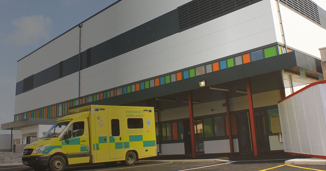 An ambulance parked in front of a hospital building