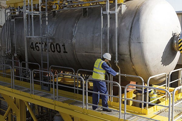 A man in safety gear working in a factory