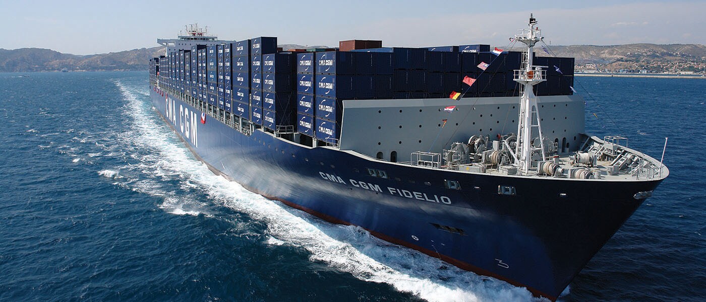 A full blue cargo ship sailing in the ocean