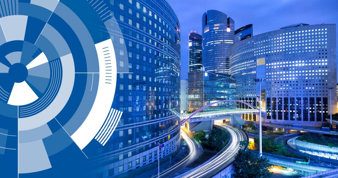 Massive round buildings at night with motion-blur cars and circular graphics in a corner