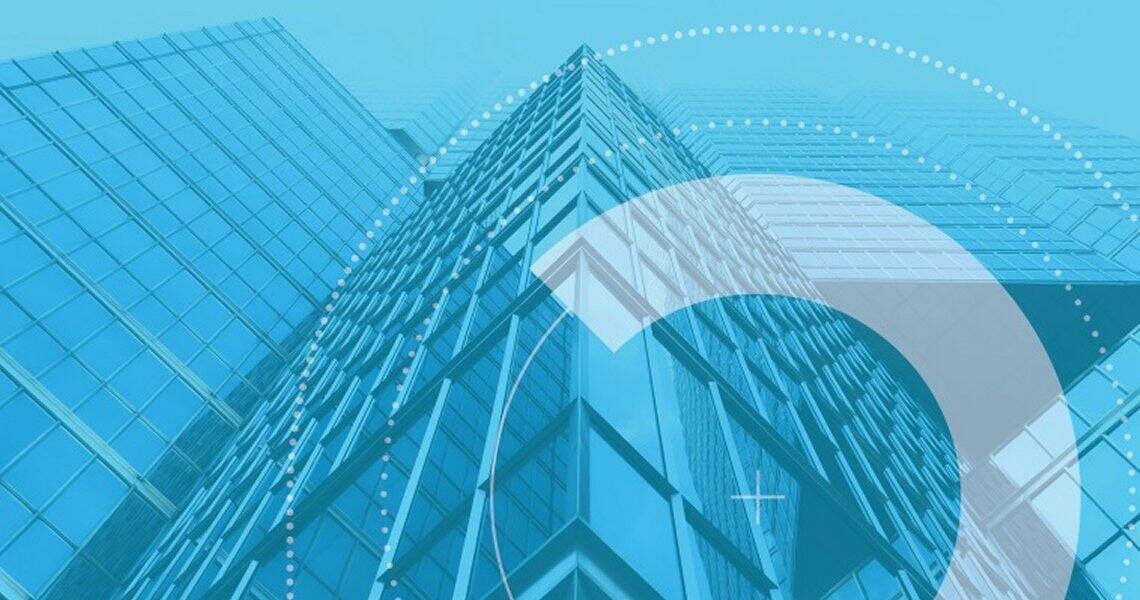 Upward shot of the exteriors of a glass building with circular graphics layered on the image