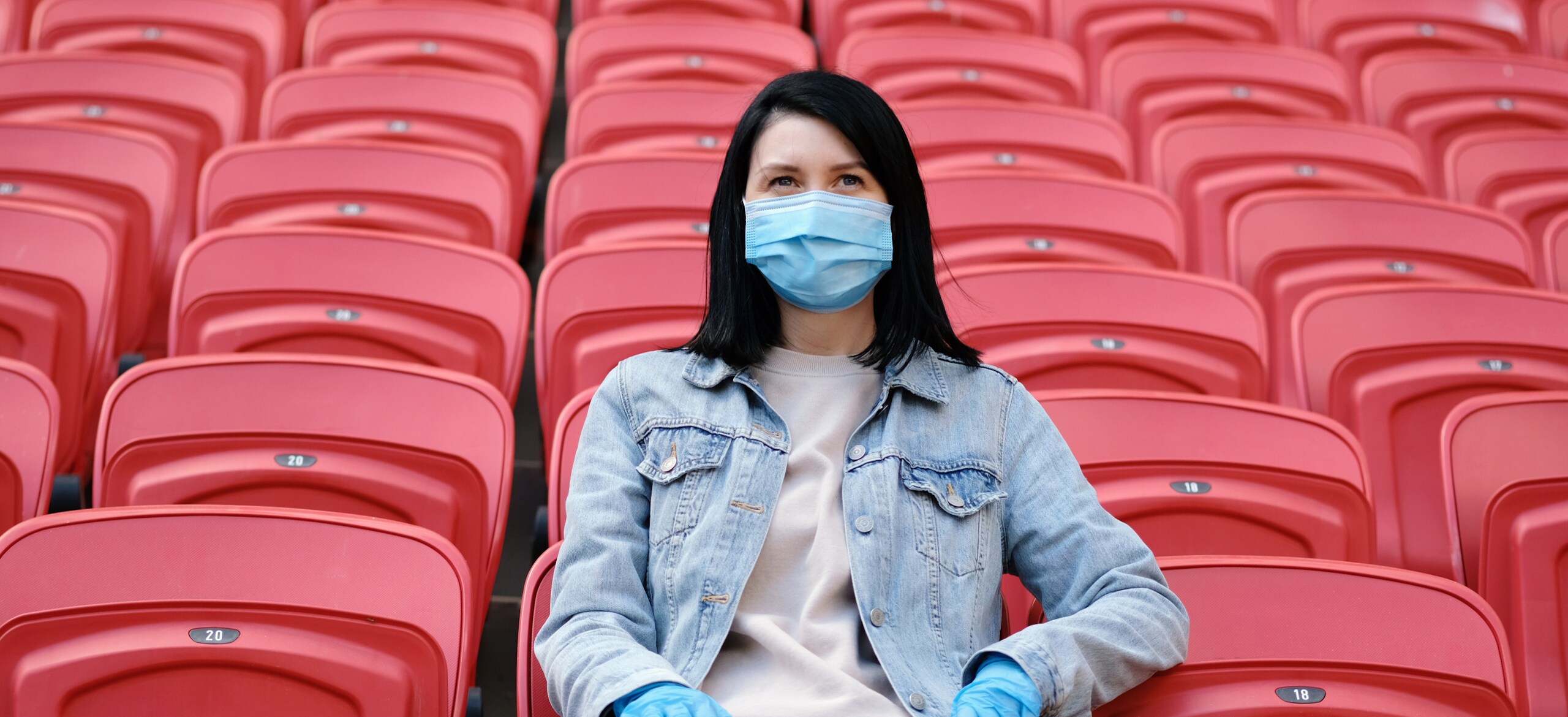 Woman sitting in a football stadium