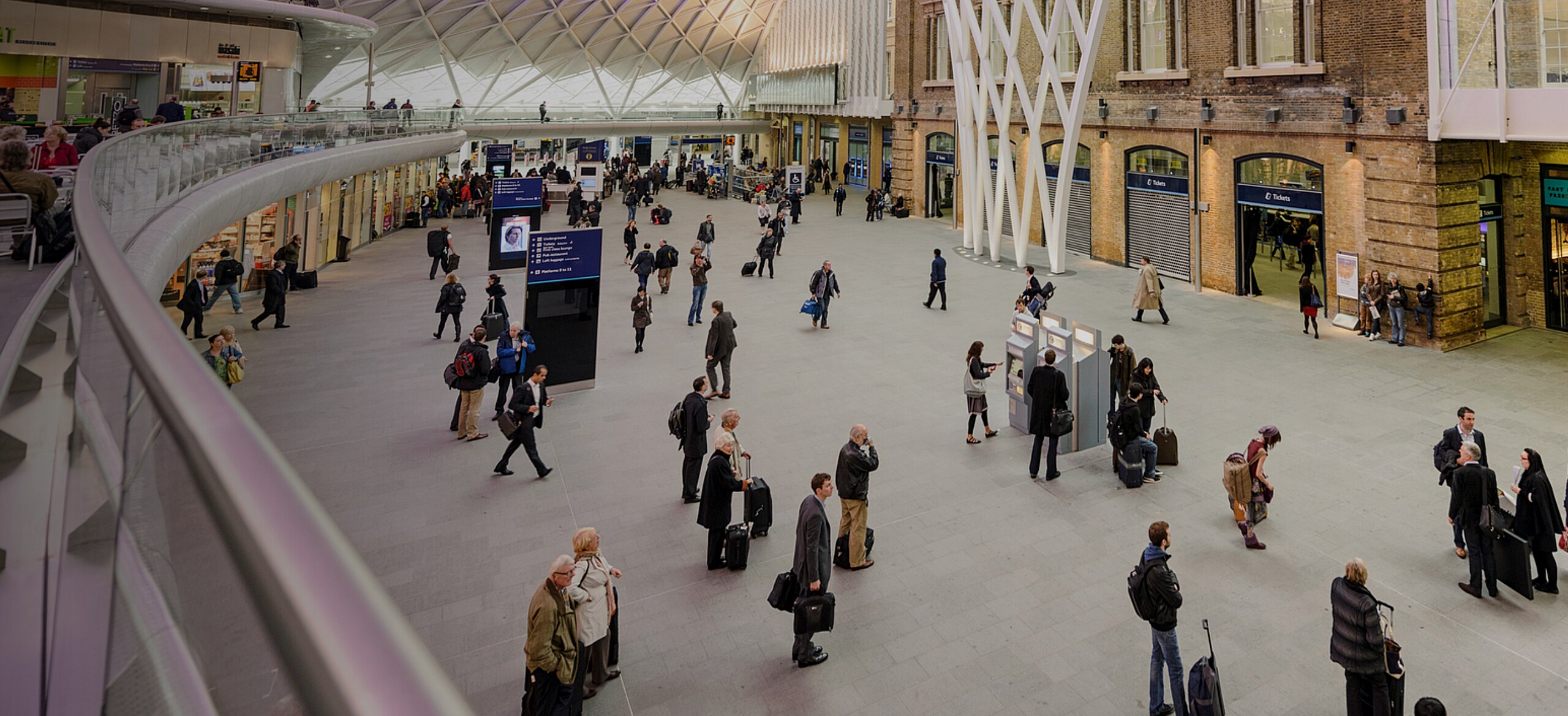 Crowd of passengers waiting at a railway station
