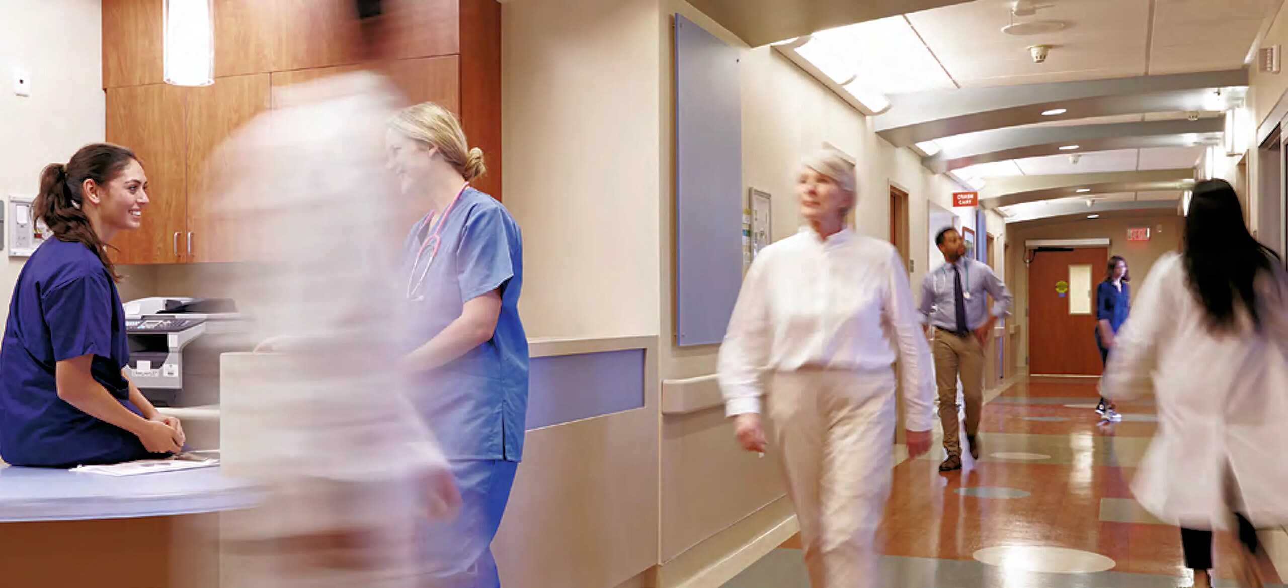 Motion blur shot of people walking in a hospital corridor