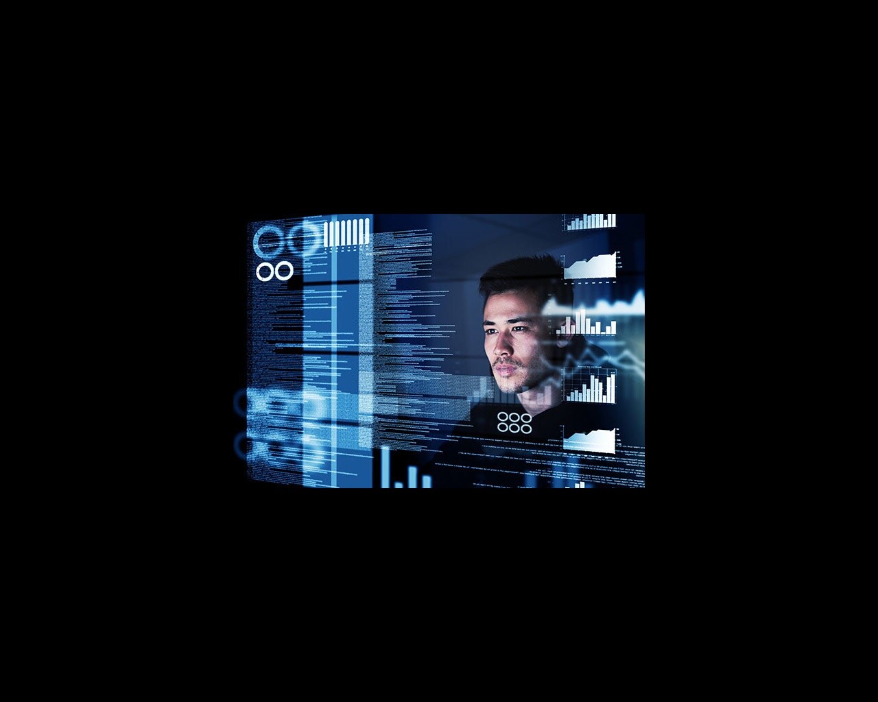 A man looking at a glass screen with text and graphs