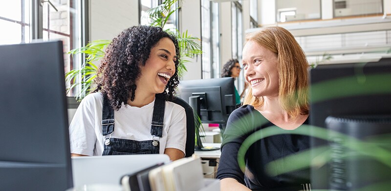 Two female associates in office