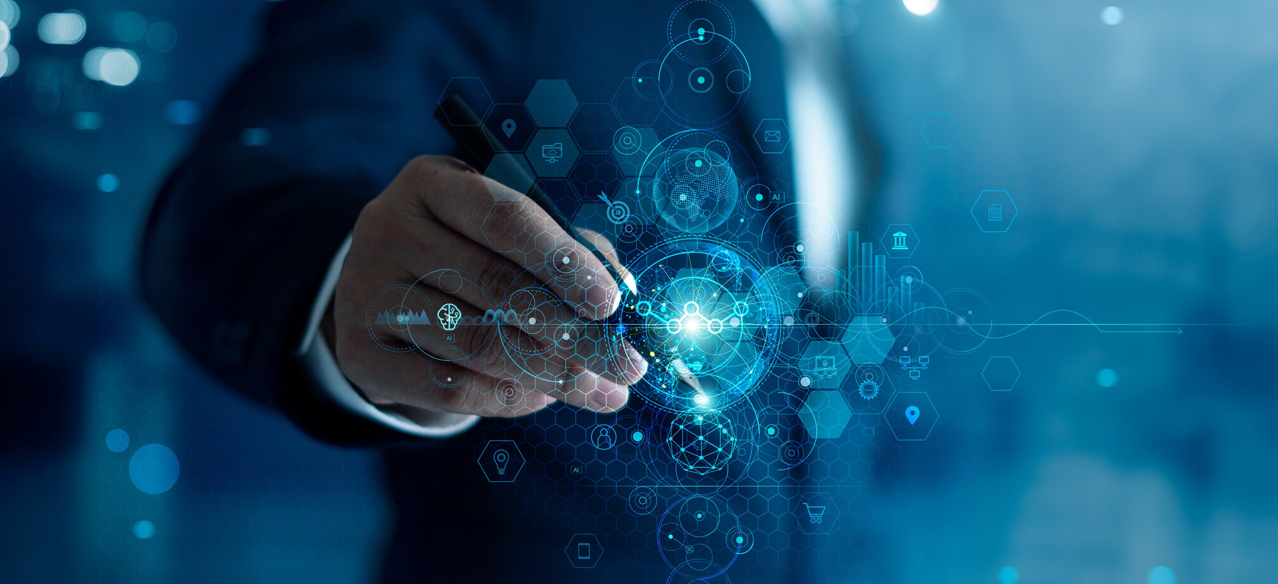 A man's hand holding an ink pen with graphics around the nib of the pen