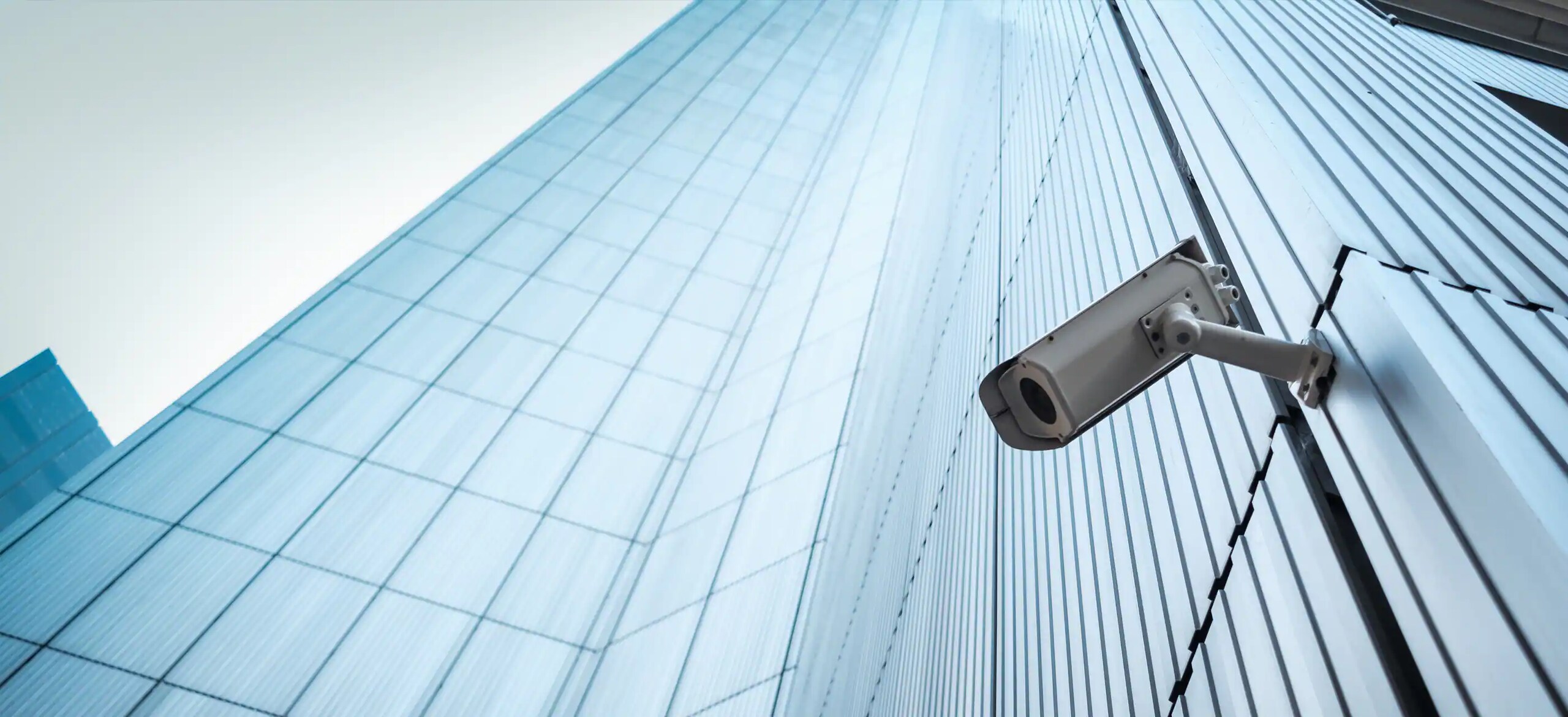A CCTV camera on the exterior of a tall skyscraper