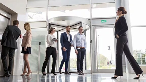 Group of employees entering office through the access control door