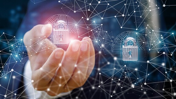 Close-up a man's hand with an overlay of locks and digital networking graphic