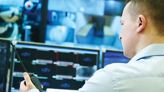 An officer analyzing cctv footage in a video surveillance room