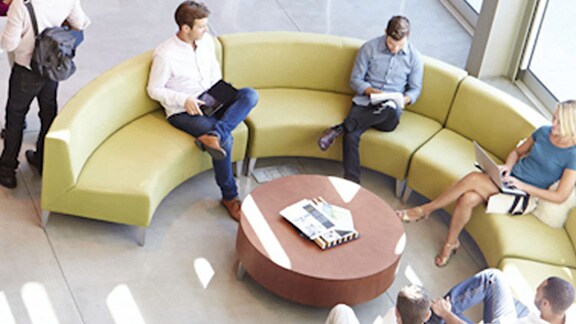 Top-angle view of people seated in an office lobby