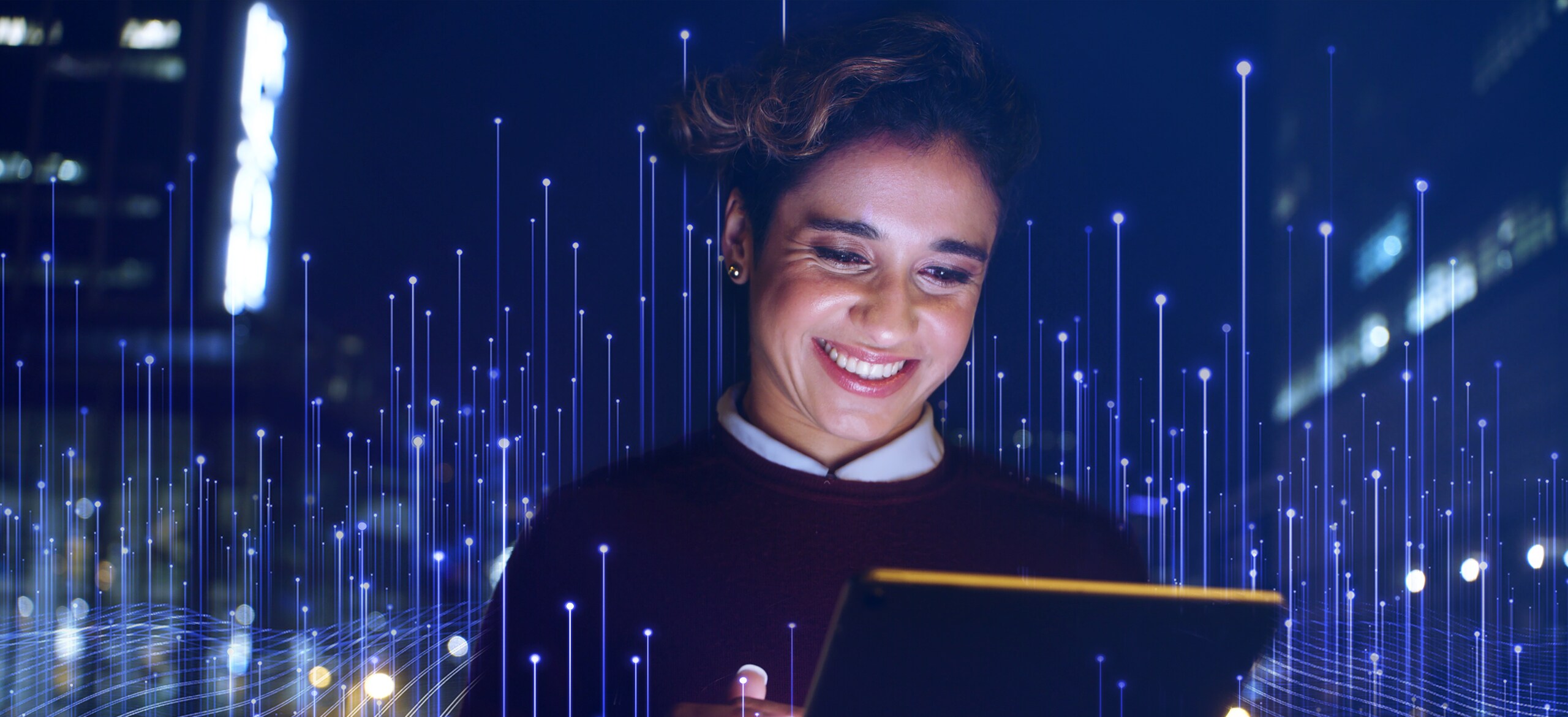 A woman looking at a tablet and smiling with modern graphics