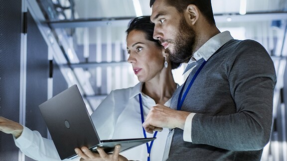 Man laptop woman control panel