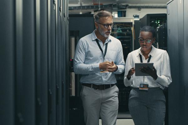 Two people discussing in front of the data center