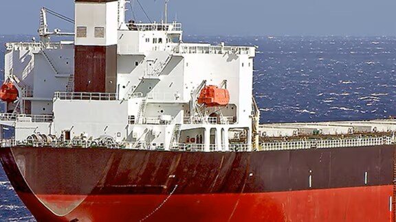 Red and white ship sailing