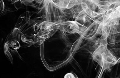 Wisps of smoke against a black background 
