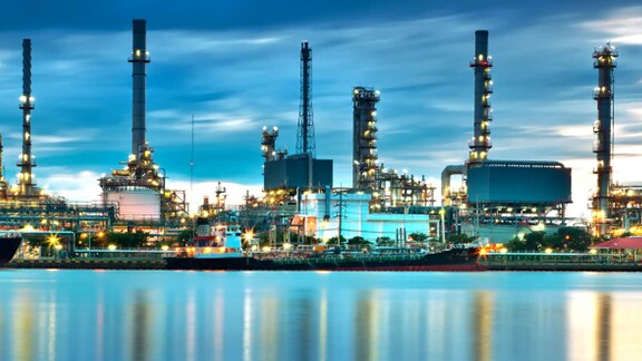 Factory near water body dusk