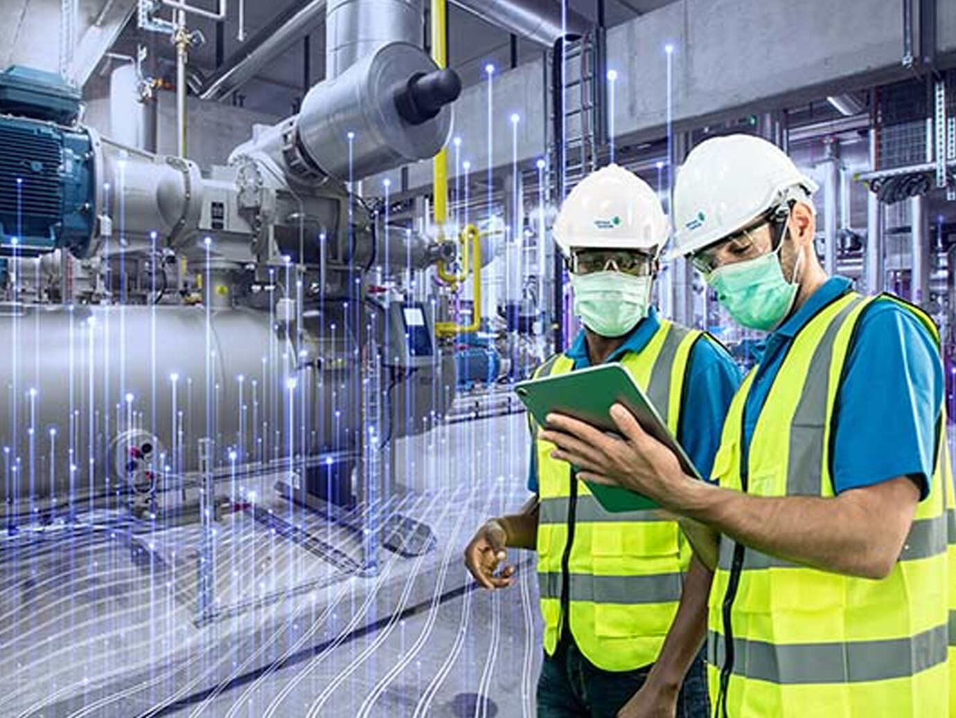 Two engineers reading a document on a writing pad in an industrial site