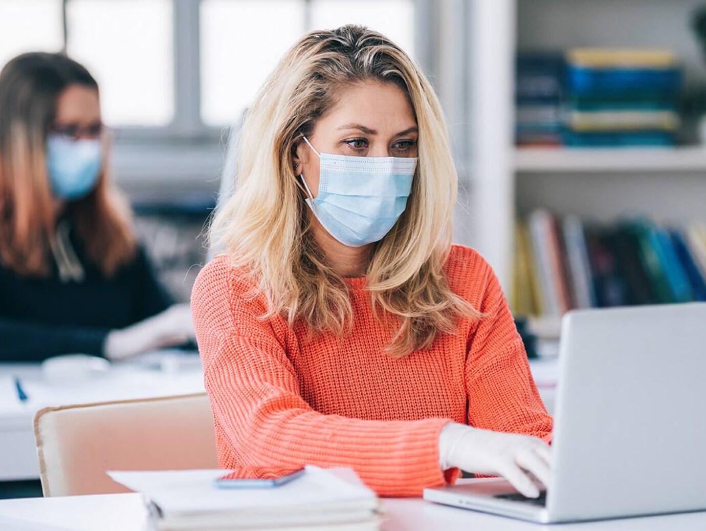 woman facemask working laptop