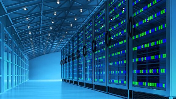 A narrow passage lined with server units in a data centre