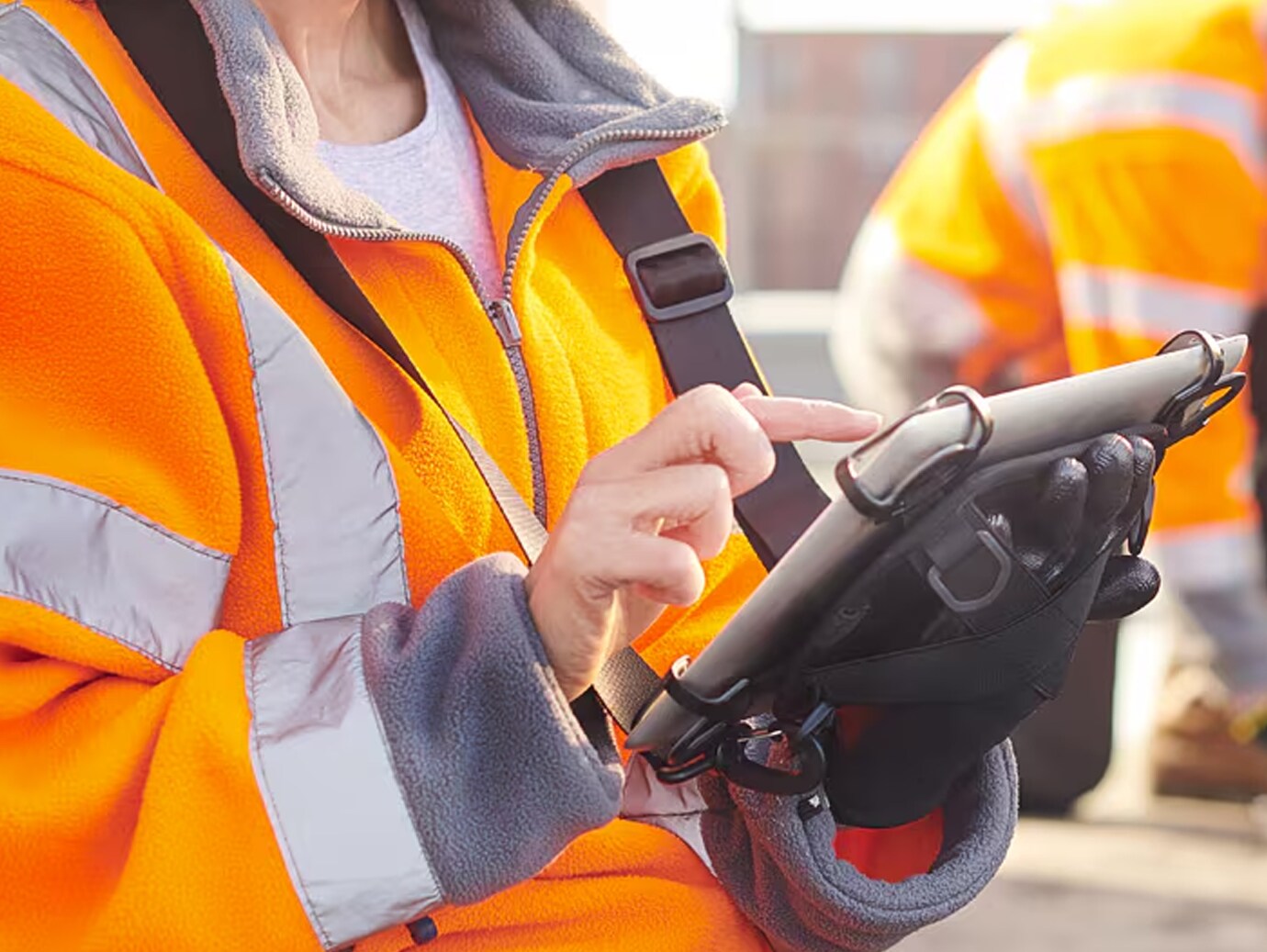 Close-up of a maintenance worker browsing a tablet