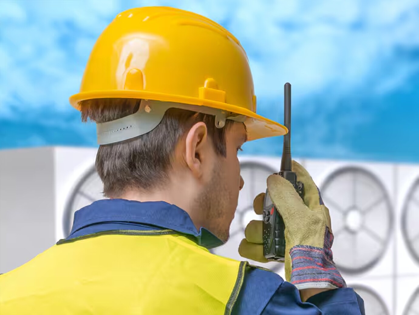 A mechanic speaking over a walkie-talkie