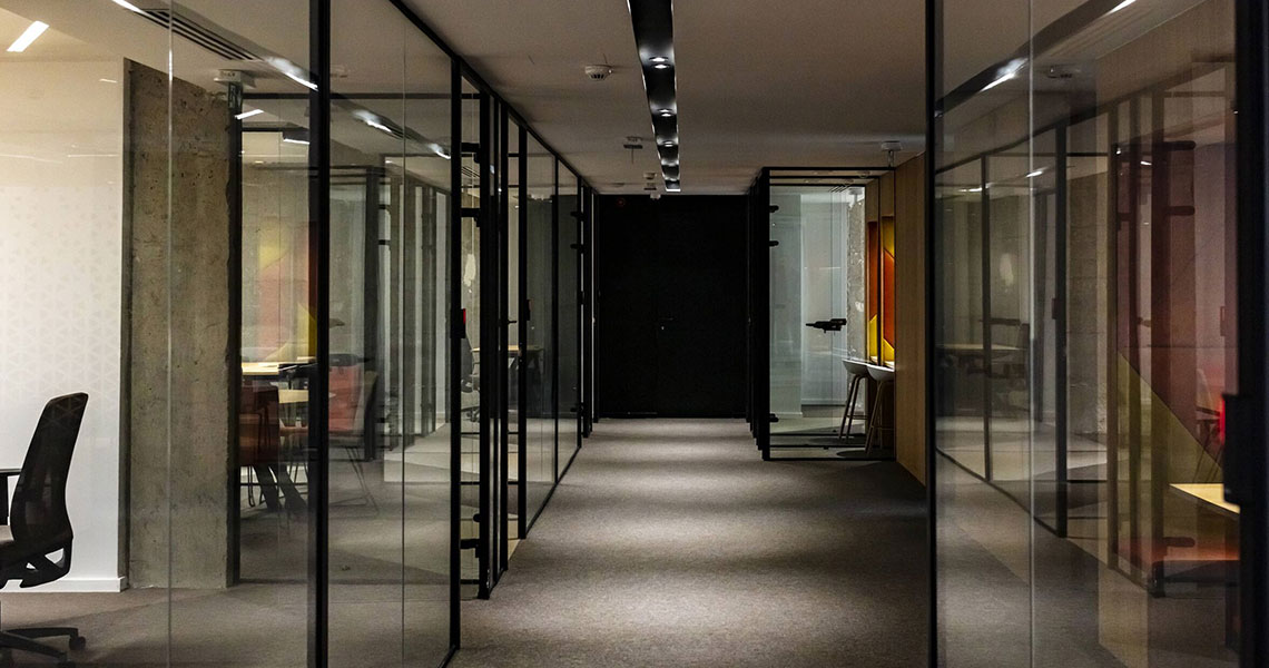 Office corridor with glass cabins on each side