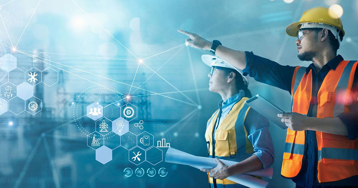 Two people wearing safety equipment, pointing at something