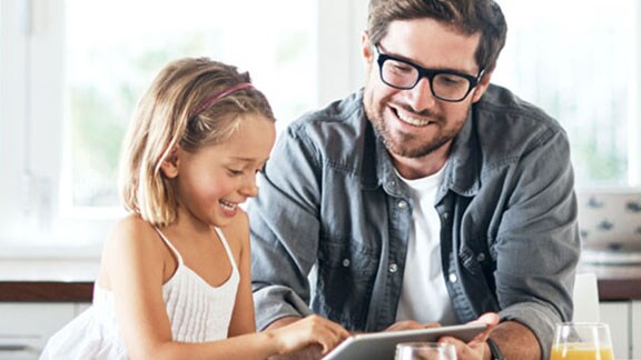 man daughter smiling at tablet