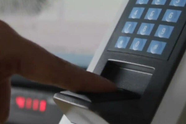 a man giving his fingerprint for Biometrics access control