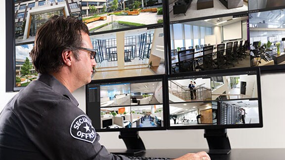 security guard examining video surveillance